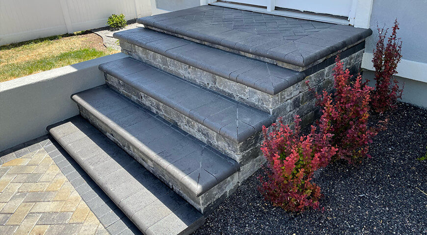 Custom stone entry steps by Lawn Care MVP landscape services.